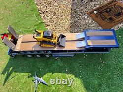 1/4 scale flat bed trailer and a low loader trailer and digger