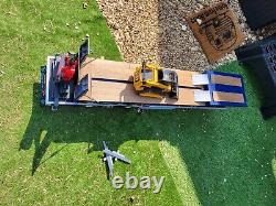 1/4 scale flat bed trailer and a low loader trailer and digger
